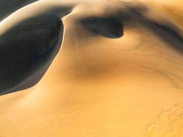 istock Smooth patterns of red sand in dunes from above 1365984007