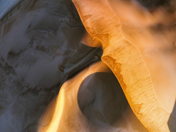 Perfect circle shadows and light on textured sand dune