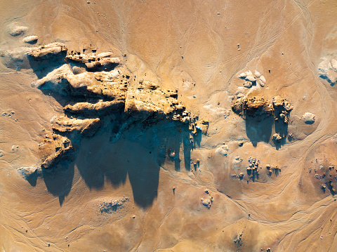 Aerial view rocky outcrop in desert landscape from above