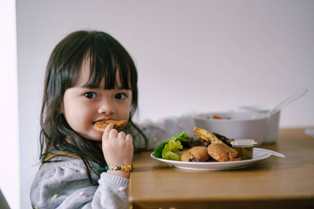 istock Young daughter having breakfast at home 1365987178