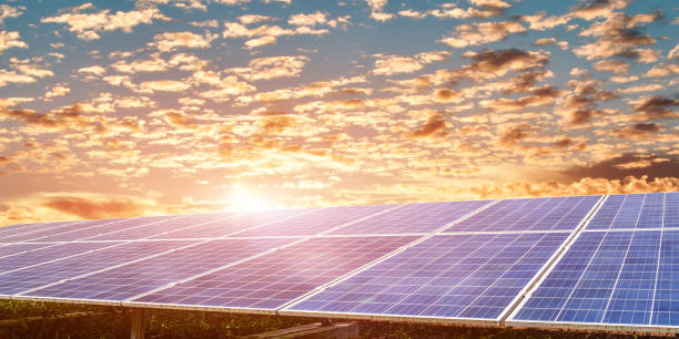 istock Solar panel with wind turbine against sunset sky background. Photovoltaic, alternative electricity source. sustainable resources concept. 1365989697