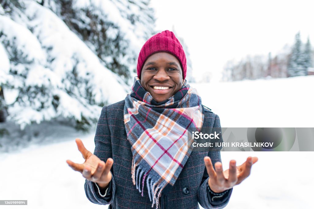 brazilian man posing outdoor in winter forest with snow bacground brazilian man posing outdoor in winter forest with snow bacground. Coat - Garment Stock Photo