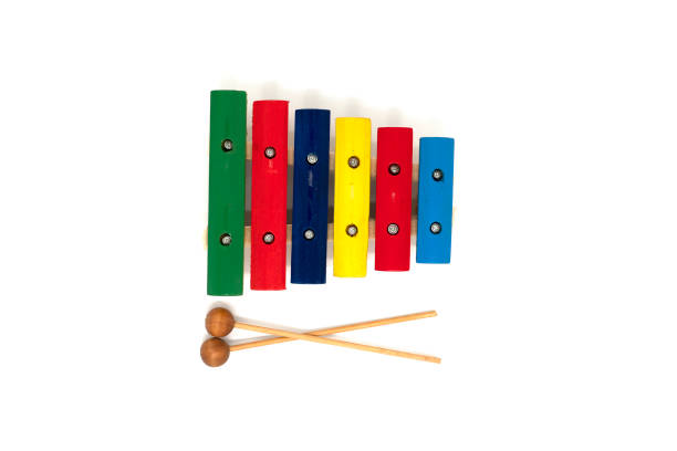 istock Rainbow colored wooden toy xylophone with two sticks on white background 1365993413