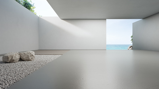 Empty floor and white gravel with concrete wall background.