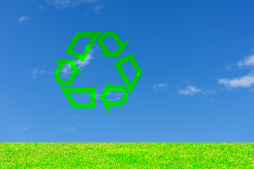 Meadow and Recycling Symbol against clear sky with copy space.
Recycling concepts.