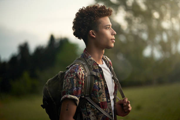 Outdoor portrait of young African-American backpacker stock photo