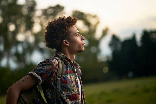 Portrait of mid 20s African-American man outdoors at dusk stock photo