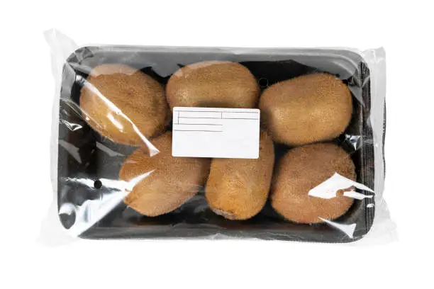 Photo of Packed and labeled kiwi on isolated white background