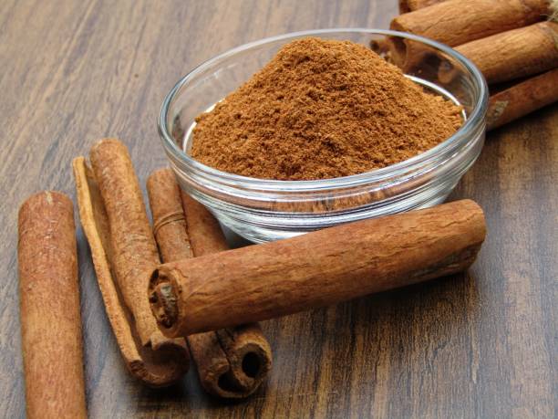 istock Cinnamon powder in a bowl With Contamination sticks 1365999278