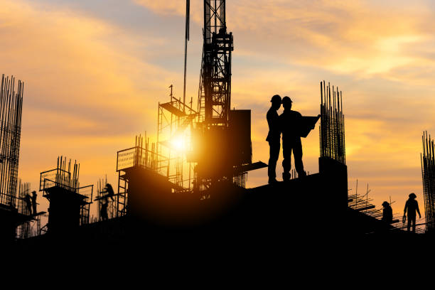 istock Silhouette of Engineer and worker team on building site, construction site with sunset in evening time 1366001834