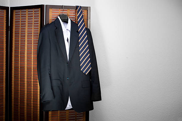istock Mens suit hanging on hangers 136600262