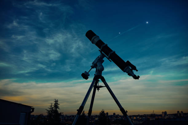 istock Big astronomical telescope under a twilight sky ready for stargazing. 1366003059