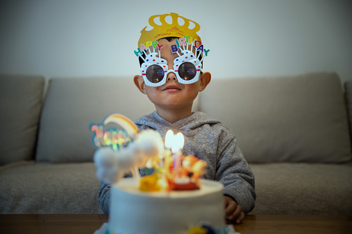 Little kid boy with his birthday cake