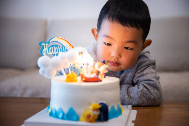 Little kid boy with his birthday cake