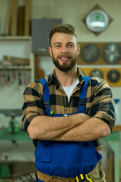 istock Portrait of smiley handsome carpenter at his workplace 1366005078