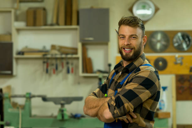 istock Portrait of smiley handsome carpenter at his workplace 1366005087