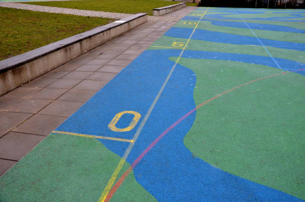 istock around game elements in spots, nursery playgrounds, there are tartan rubber surfaces made of crushed rubber glued together. rope center with trampoline. handprint in frozen hoarfrost, melting 1366007462