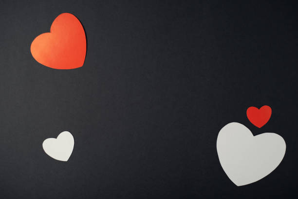 istock Red and white paper hearts on a black background. 1366008344