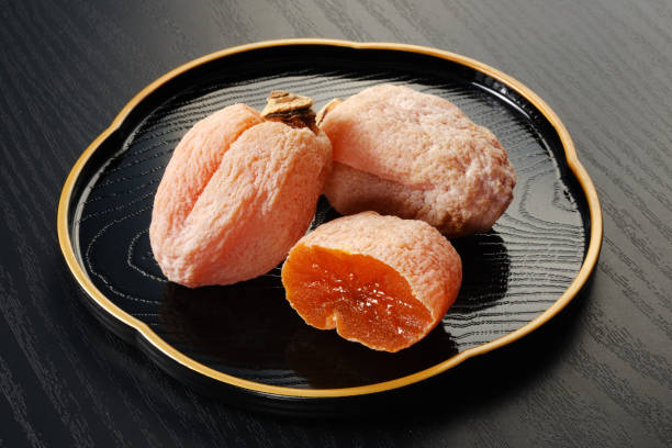 istock Japanese dried persimmon on wooden table 1366009476