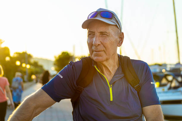 istock Serene men observing the marina while pushing his bike 1366014276