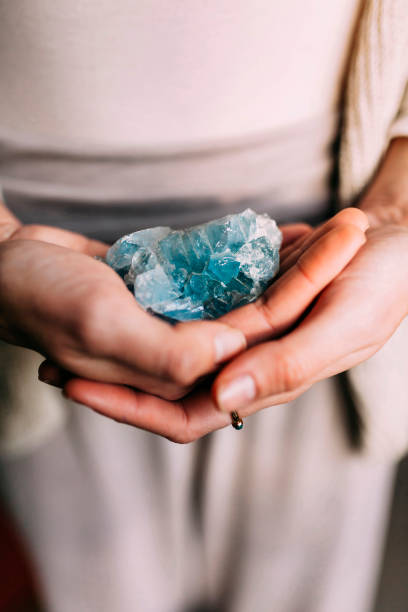 istock Woman holding celestine geode indoors 1366014284