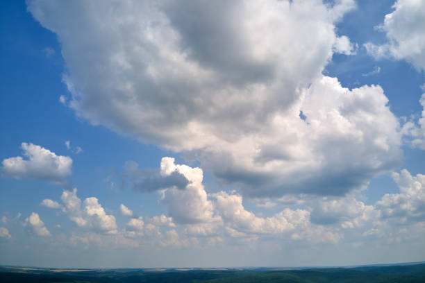 Bright landscape of white puffy cumulus clouds on blue clear sky Bright landscape of white puffy cumulus clouds on blue clear sky. stratosphere meteorology climate air stock pictures, royalty-free photos & images