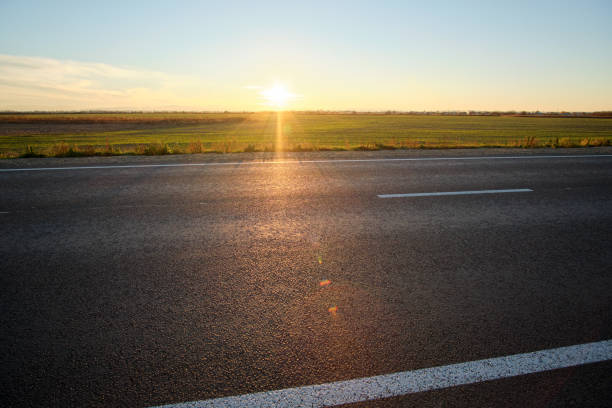istock Empty intercity road with asphalt surface and white markings in evening 1366017816