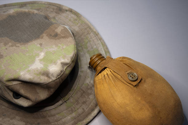 istock an old military water flask next to a camouflage panama 1366018996