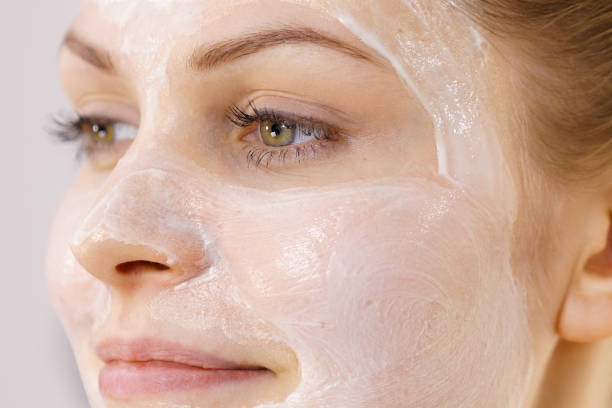 istock Girl with cream moisture cosmetic on face 1366020083