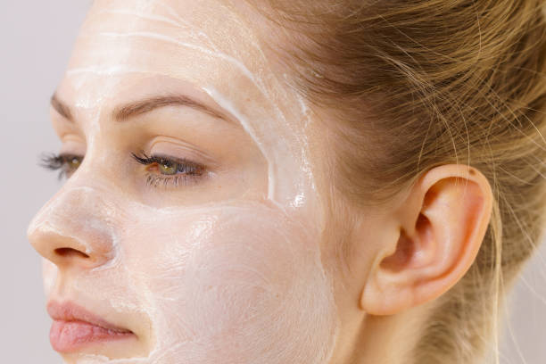 istock Girl with cream moisture cosmetic on face 1366020150