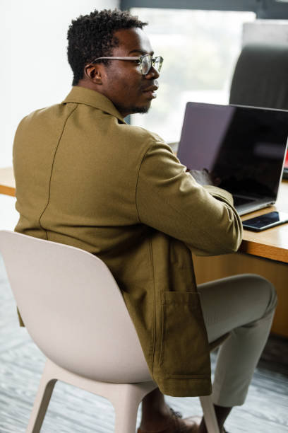 istock Businessman contemplating a response to an email he is tying 1366020226