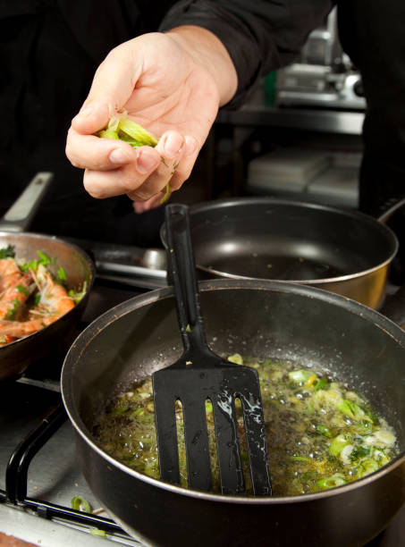 istock Chef frying chopped spring onion in a pot 1366020318