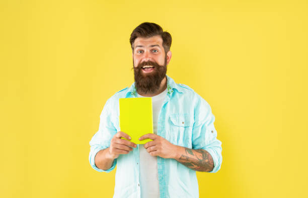 istock amazed bearded man with planner on yellow background, daily planning 1366021121