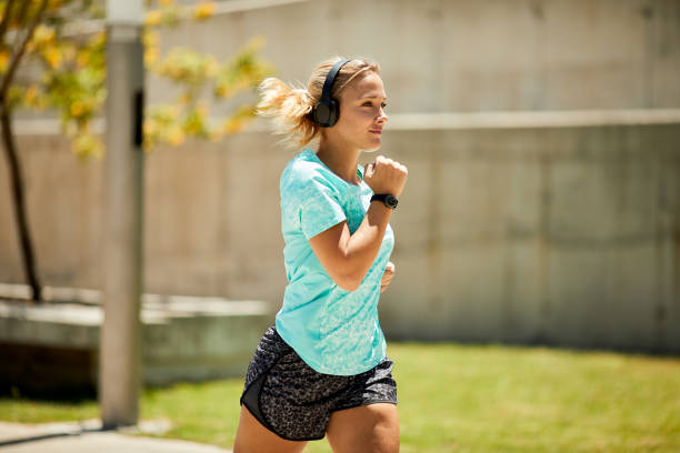 istock A woman running in a park on a spring morning. 1366021388
