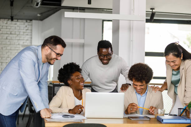 istock Business people having fun and laughing while working together 1366021528