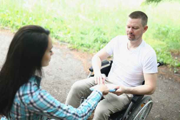 istock A man in a wheelchair in makes notes 1366021672