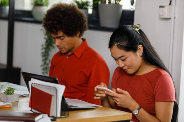 istock Young businesswoman using smart phone when taking a break during a meeting 1366021924