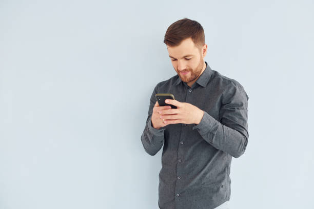 istock Man in grey shirt is posing indoors against white background 1366022265