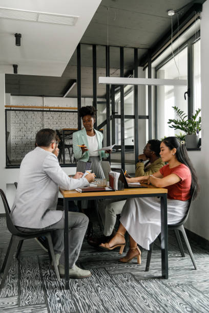 istock Confident female CEO leading a meeting at the modern office 1366022331