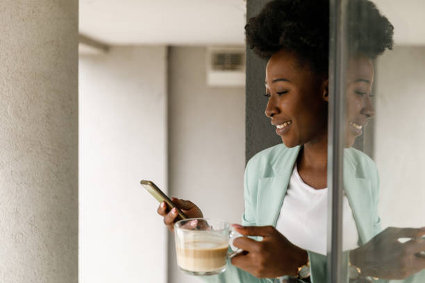istock Responding to texts and breathing fresh air on the window during coffee break 1366022354