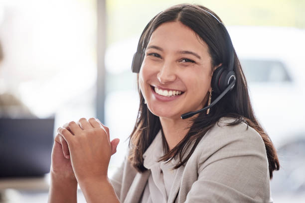 Cropped portrait of an attractive young female call center agent working in her office I'm glad I could help call center stock pictures, royalty-free photos & images