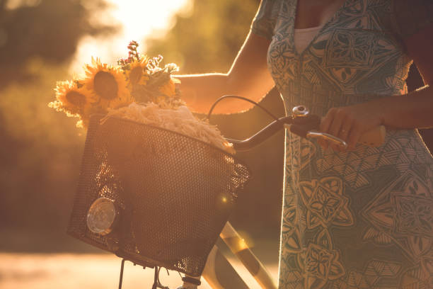 istock Unrecognizable woman pushing her bike while going for a walk 1366023562