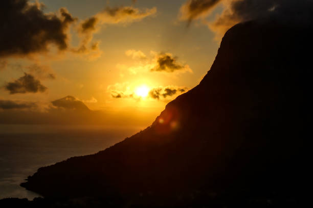The sunset reflected fast moving evening time in its character. Clouds were gathering around the horizon. And only mountain in the shade seemed to be a special guest of the evening charm...