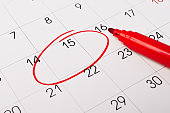 istock Calendar page with red pen close up. Focus on number 15 in calendar and empty red circle for design in your ideas and work concept 1366026792