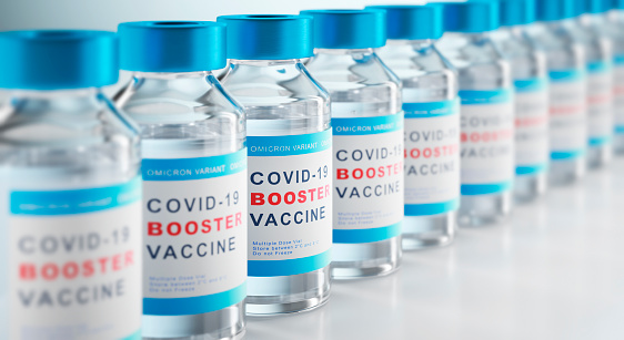 Row of bottles of vial on light gray background for booster vaccination or booster shot or dose