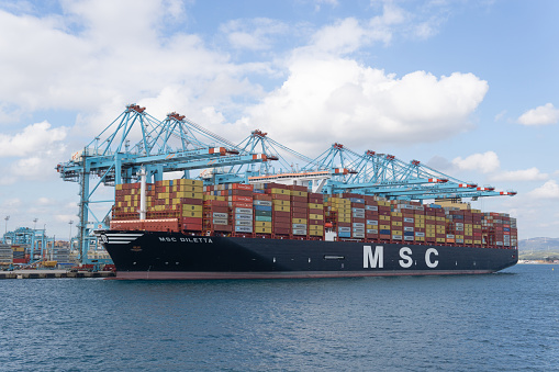 Algeciras, Cadiz Spain; 20 January 2022: A MSC freighter is docked on harbor, Container ship at industrial port in import export business logistic and transportation of international