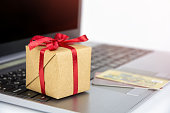Gift box and credit cards on laptop