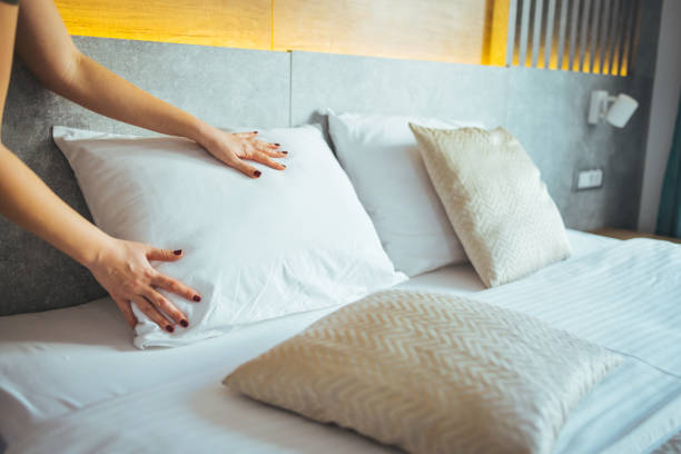 istock Maid making bed in hotel room. 1366029057