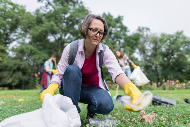 istock Three people cleaning the park 1366030308