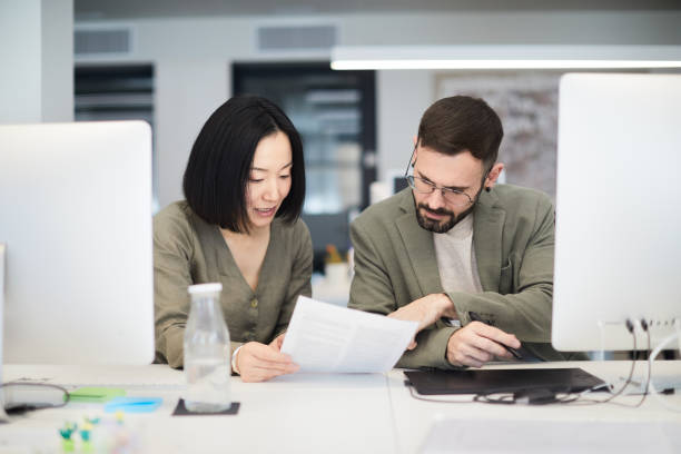 istock Two colleagues are working together on a new project. 1366030827